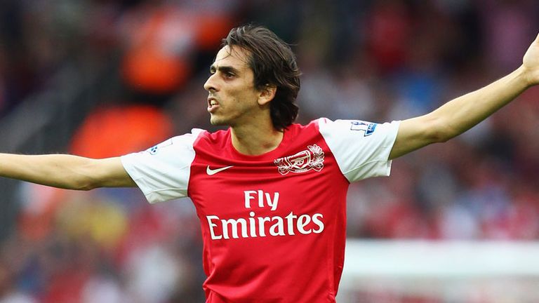 Image of Arsenal FC player Yossi Benayoun holding his hands out during a football match.